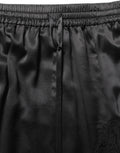 Dolce & Gabbana Schwarzer Satinrock mit Spitzendetails und seitlichem Schlitz