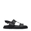 Versace Schwarze flache Sandalen aus Leder