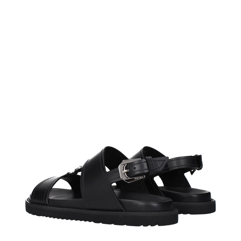 Versace Schwarze flache Sandalen aus Leder