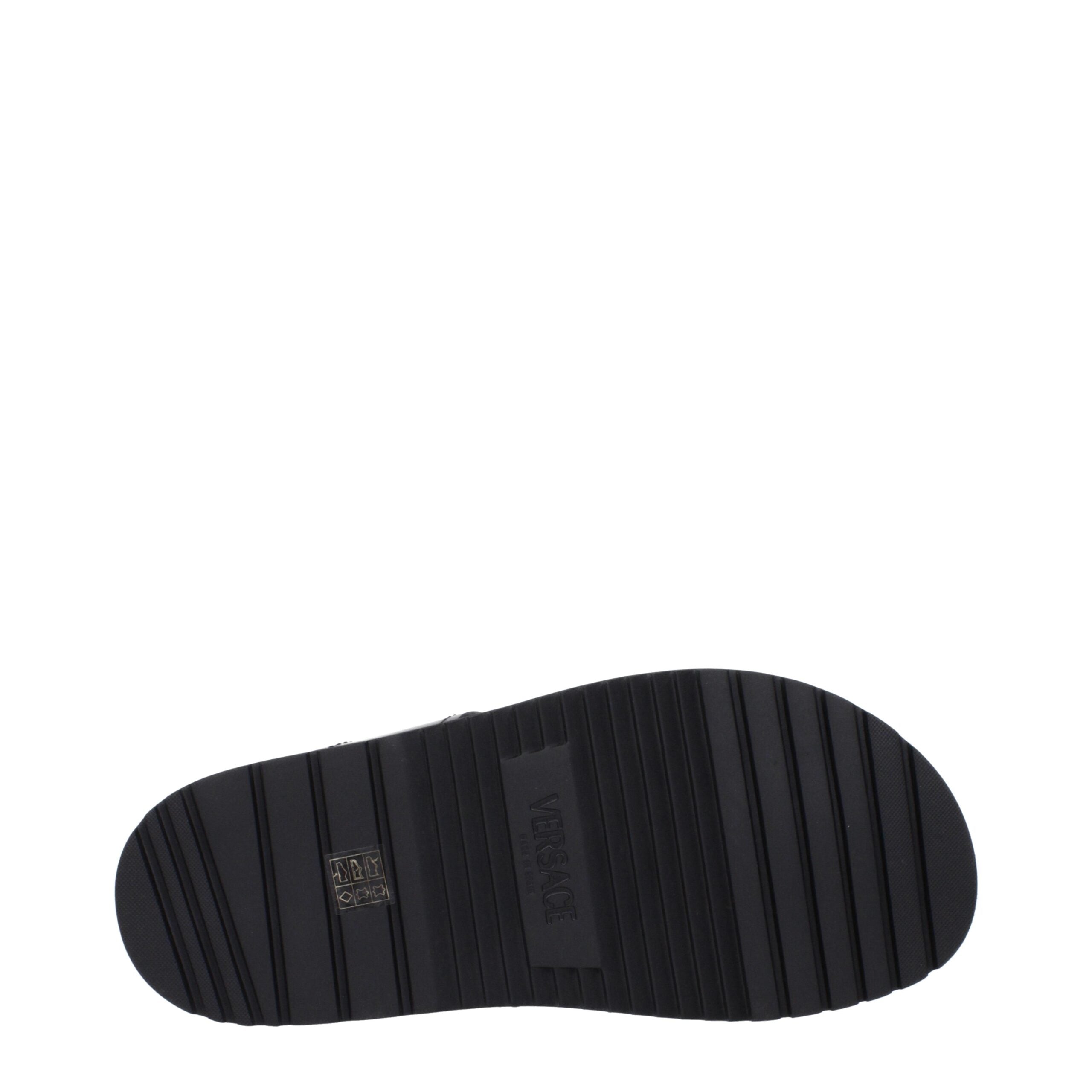 Versace Schwarze flache Sandalen aus Leder
